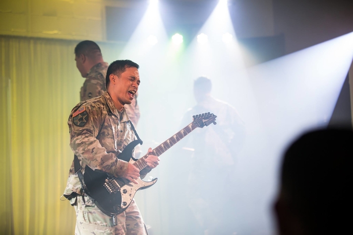 Kenneth playing guitar in the US Army band